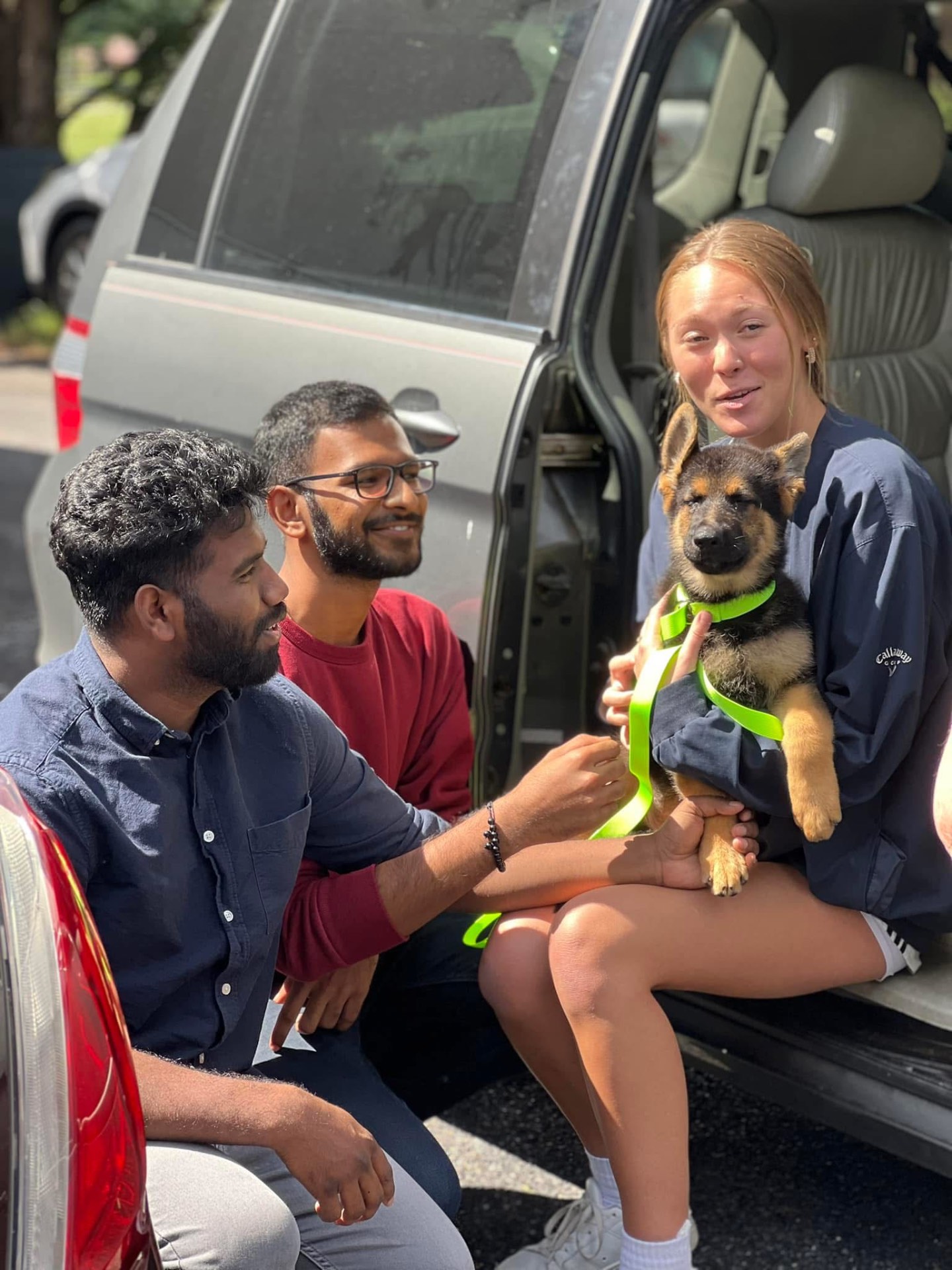 Family welcoming home a Haus Von Wolfgang Mojica puppy